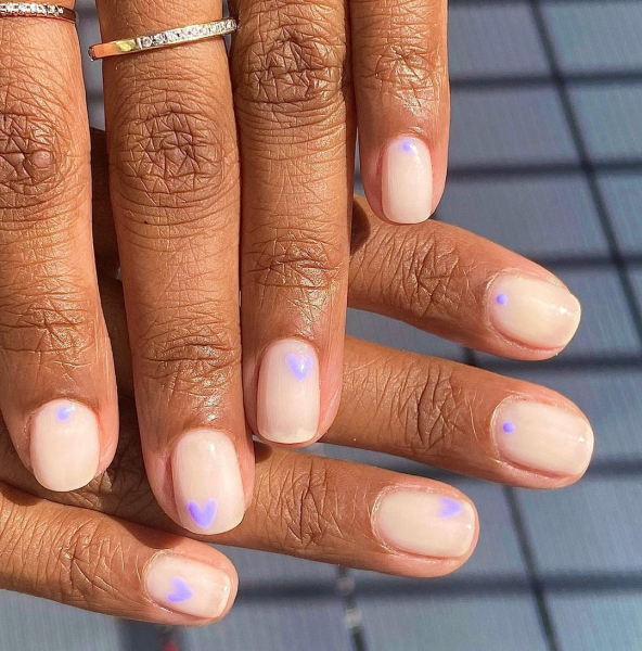 Easter nails pastel purple hearts on beige polish
