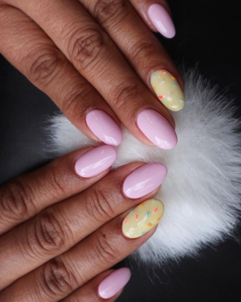 easter nails pink and yellow nail polish with sprinkles